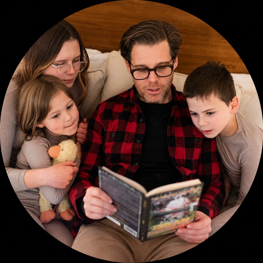 Family gathered around a book