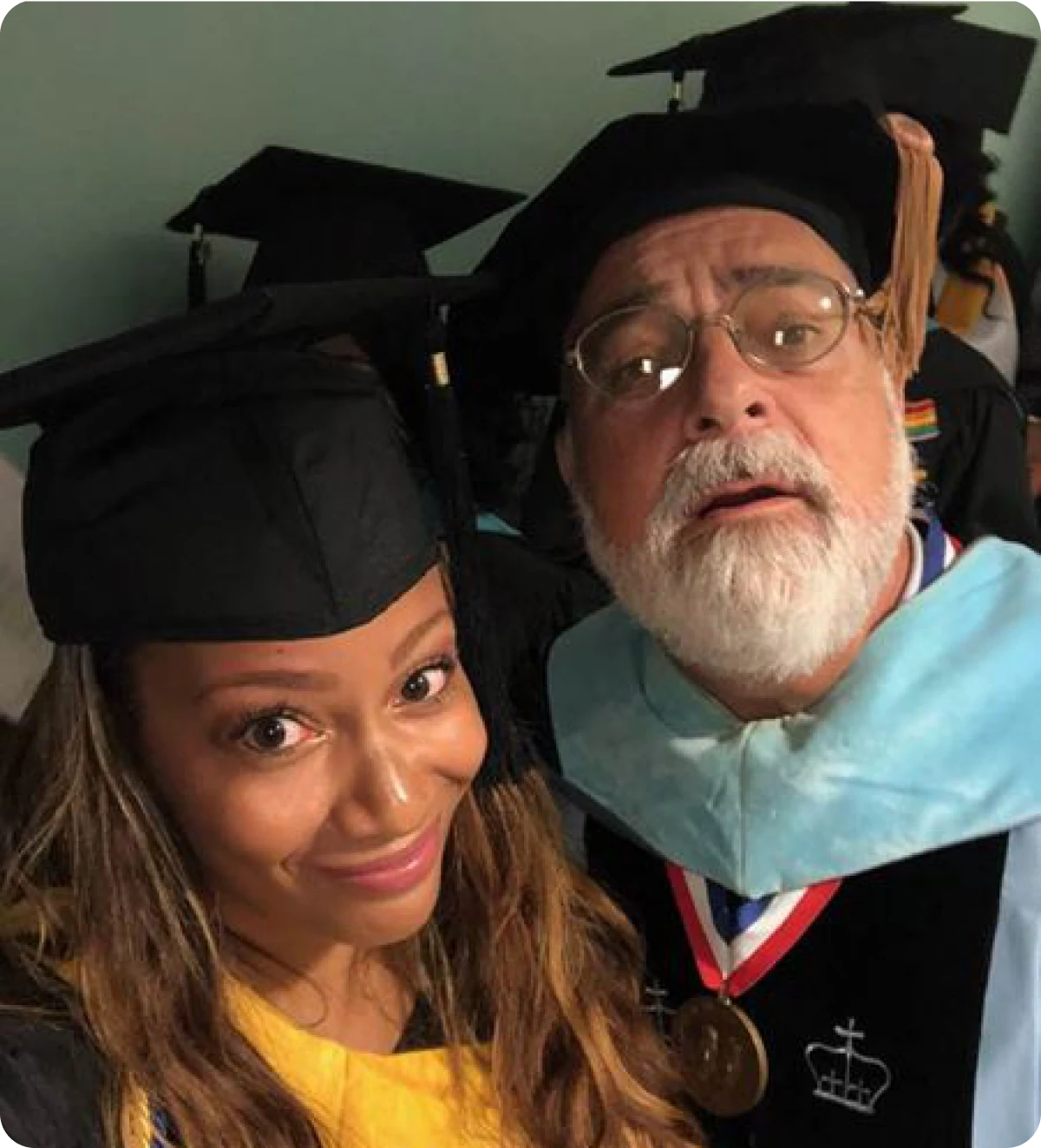 Graduates smiling in caps and gowns